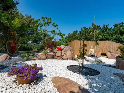 a garden with rocks and flowers in a yard at Holiday Home Campestra by Interhome in Coti-Chiavari