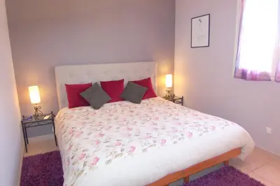 a bedroom with a large bed with red pillows at CELESTE in Capo