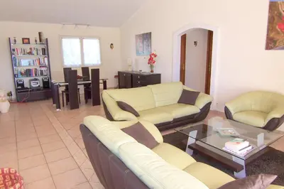 a living room with two couches and a table at CELESTE in Capo