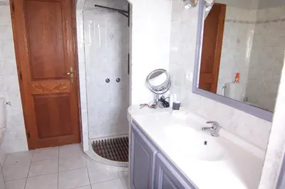 a bathroom with a sink and a shower with a mirror at CELESTE in Capo