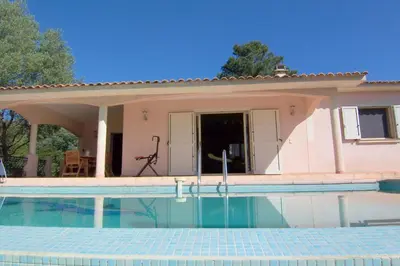 a villa with a swimming pool in front of a house at CELESTE in Capo