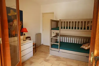a bedroom with two bunk beds and a mirror at Grande Villa, Corse du Sud, Domaine privé de Cala Rossa in Porto-Vecchio