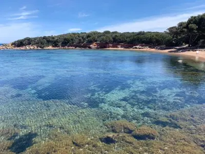 a large body of water with a beach and reefs at Grande Villa, Corse du Sud, Domaine privé de Cala Rossa in Porto-Vecchio