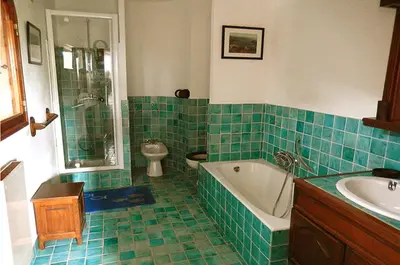 a bathroom with a tub and a toilet and a sink at Grande Villa, Corse du Sud, Domaine privé de Cala Rossa in Porto-Vecchio