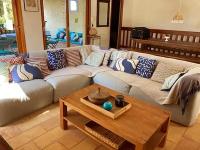 a living room with a couch and a coffee table at Grande Villa, Corse du Sud, Domaine privé de Cala Rossa in Porto-Vecchio