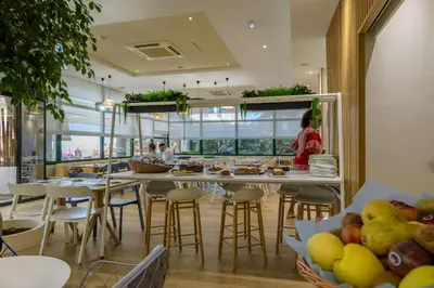 a restaurant with tables and chairs and people in the background at Residence de Tourisme Ajaccio Amirauté in Ajaccio