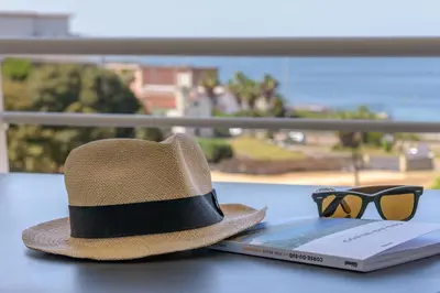 a hat and sunglasses sitting on top of a book at Residence de Tourisme Ajaccio Amirauté in Ajaccio
