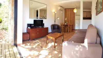 a living room with a couch and a table at A ALTEZZA Palombaggia in Porto-Vecchio