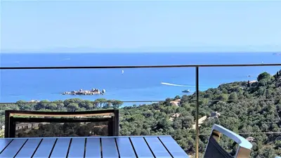 a view of the ocean from the balcony of a house at A ALTEZZA Palombaggia in Porto-Vecchio