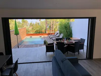 a living room with a patio with a table and chairs at Residence Mare e Monte in Favone