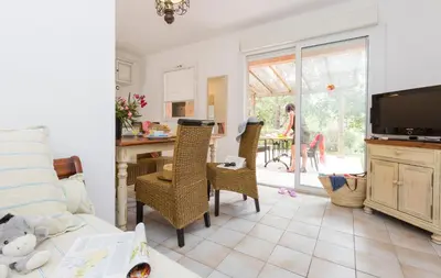 a kitchen with a table and chairs and a kitchen with a staircase at Residence Mare e Monte in Favone
