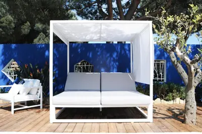 a white swing on a deck with a tree at Les Suites d'Agosta in Porticcio