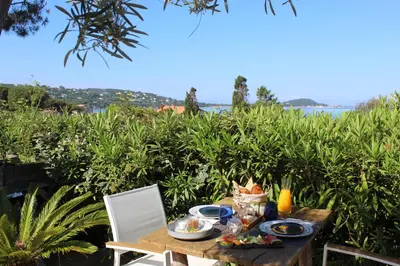 a wooden table with food on top of a field at Les Suites d'Agosta in Porticcio