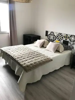a bedroom with a large white bed with pillows at Corté Centre Corse in Corte