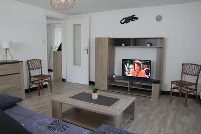 a living room with a couch and a tv at Bottega in Petreto-Bicchisano