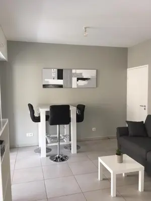 a living room with a couch and a table at Studio les pieds dans l'eau Plage du Trottel in Ajaccio