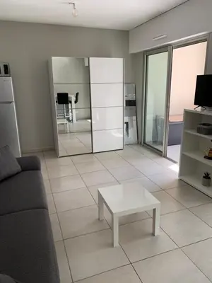 a living room with a couch and a coffee table at Studio les pieds dans l'eau Plage du Trottel in Ajaccio