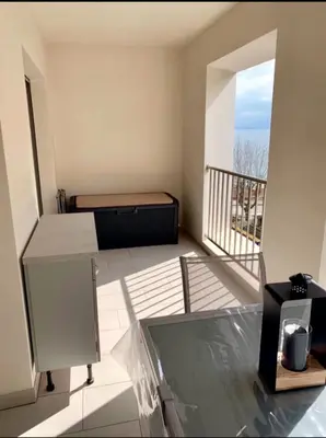 a bedroom with a bed and a balcony at Studio les pieds dans l'eau Plage du Trottel in Ajaccio