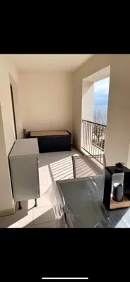 a room with a bed and a balcony at Studio les pieds dans l'eau Plage du Trottel in Ajaccio