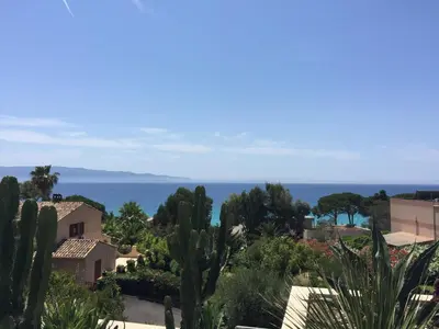 a view of a town with trees and the ocean at Barbicaja in Ajaccio