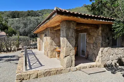 a small stone building with a porch and a door at Domaine Valle Doniche in Olmeto
