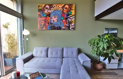 a living room with a couch and a painting on the wall at residence de porticcio, youyoube in Porticcio