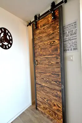 a wooden door in a room with a wall at residence de porticcio, youyoube in Porticcio
