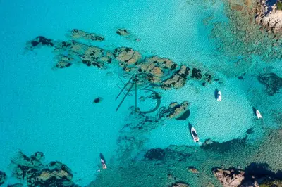 an aerial view of a beach with boats in the water at residence de porticcio, youyoube in Porticcio