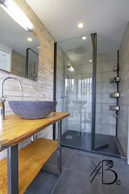 a bathroom with a large stone sink and a shower at residence de porticcio, youyoube in Porticcio