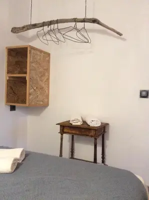 a bedroom with a bed and a wooden table at Le studio in Porto-Vecchio
