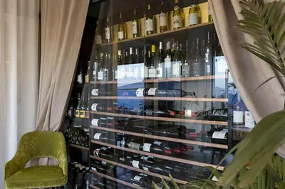 a display of bottles of wine in a window at Hôtel Capo Rosso in Piana