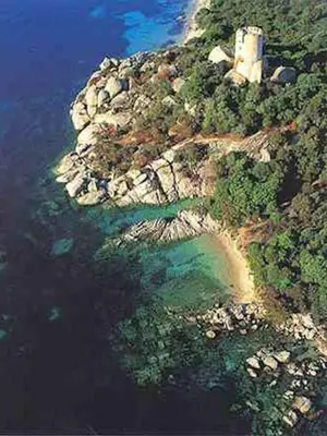 an aerial view of an island with a lighthouse on it at La Baraka in Pianottoli-Caldarello