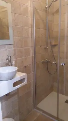 a bathroom with a shower and a sink at La Baraka in Pianottoli-Caldarello