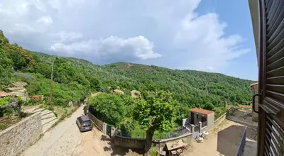 a car parked on a dirt road next to a mountain at Maison de Vacances Renno in Renno