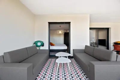a living room with two couches and a table at Domaine du Frassu, T2 standing, plage à pied in Porticcio