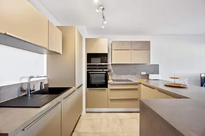 a kitchen with a sink and a stove top oven at Domaine du Frassu, T2 standing, plage à pied in Porticcio