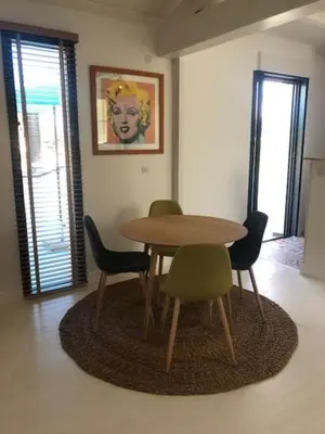 a dining room with a table and four chairs at Oliera 2 in Oletta