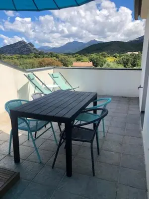 a table and chairs on a balcony with a view at Oliera 2 in Oletta
