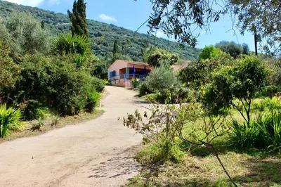 a dirt road in front of a house at Résidence Itylon in Cargèse