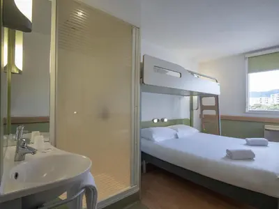 a bathroom with a sink and a bunk bed at ibis budget Ajaccio in Ajaccio