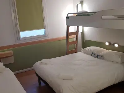 a bedroom with two beds and a bunk bed at ibis budget Ajaccio in Ajaccio