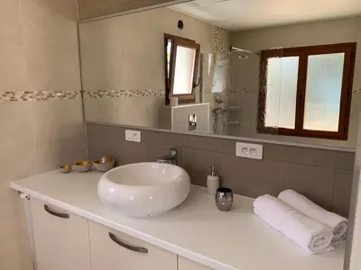 a bathroom with a sink and a mirror at Résidence Les Mandiles in Cargèse