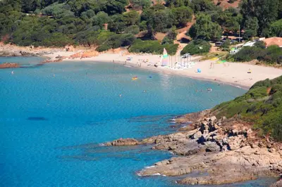 an aerial view of a beach with people in the water at Residence Helios in Cargèse