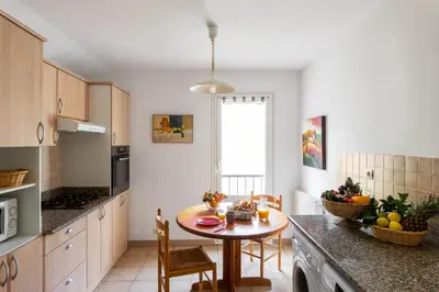 a kitchen with a sink and a washing machine at Residence Helios in Cargèse