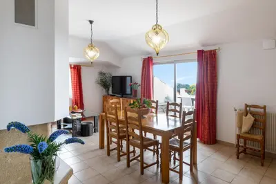 a kitchen with a table and a dining room at Residence Helios in Cargèse