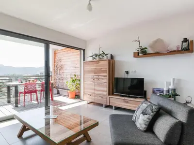 a living room with a couch and a tv and a table at Apartment Résidence Cita di Sali-9 by Interhome in Porto-Vecchio