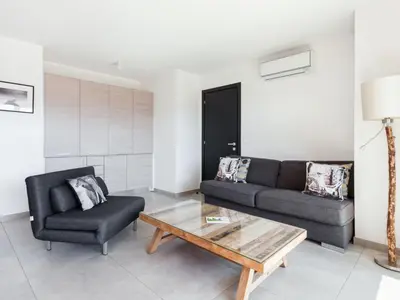 a living room with a couch and a coffee table at Apartment Résidence Cita di Sali-9 by Interhome in Porto-Vecchio