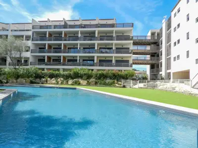 a swimming pool in front of a building at Apartment Résidence Cita di Sali-9 by Interhome in Porto-Vecchio