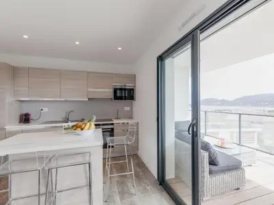 a kitchen and living room with a table and chairs at Apartment Château-10 by Interhome in Porto-Vecchio