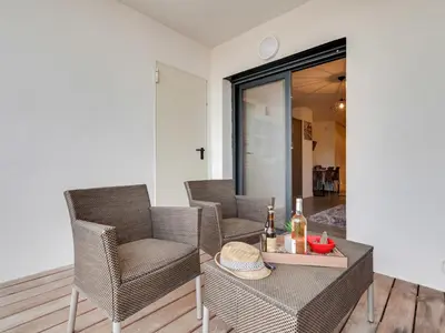 a balcony with chairs and a table with a view at Studio Château-11 by Interhome in Porto-Vecchio